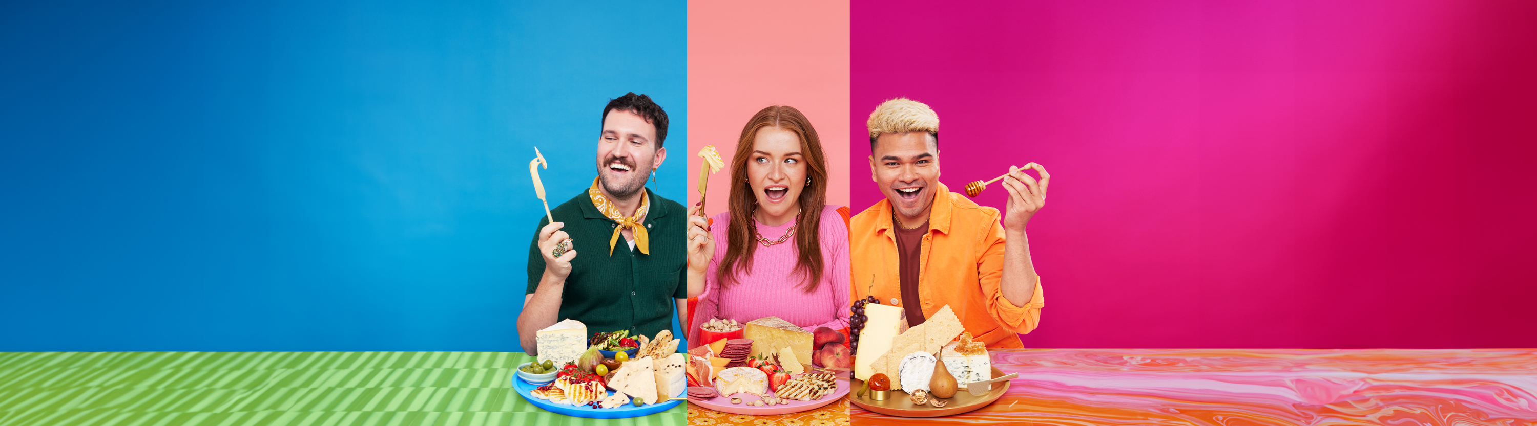 Three people are posing with their stylised cheeseboards.
