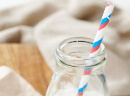 Bottle of milk with a straw