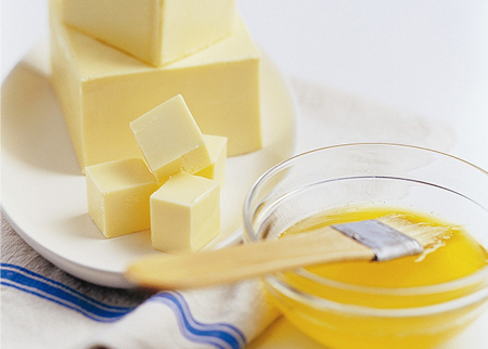 Cubes of butter and melted butter in a bowl