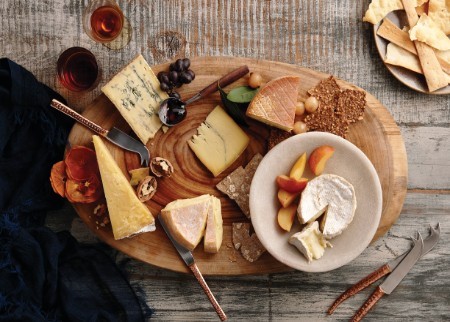 Beautiful wooden platter laden with cheese and fruit