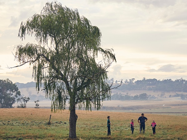 Australian dairy environmental commitment | Farmer planting trees 