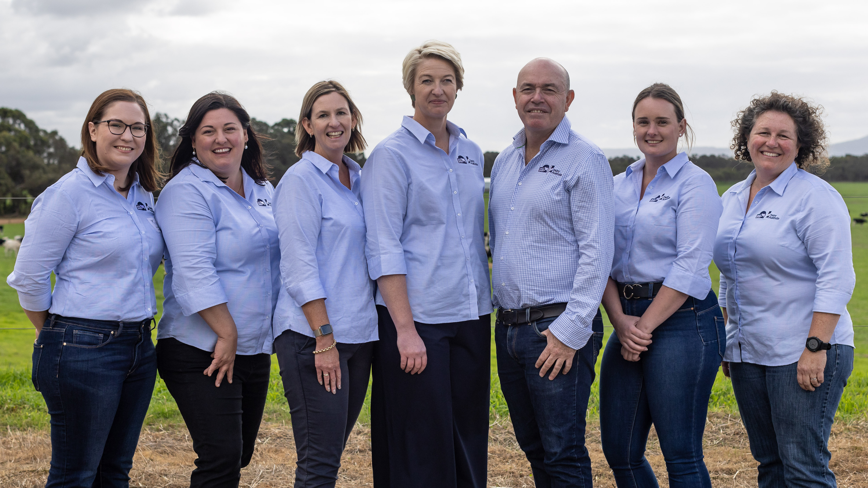 The Western Dairy team standing together outside in a paddock. 